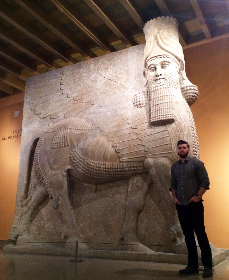 Paul Khio stands in front of an Assyrian winged bull, also called a Lamassu, at the Oriental Institute Museum’s Assyrian gallery in Chicago. The figure behind him is similar to what radical Islamic militants destroyed in Iraq. “History is the yearni