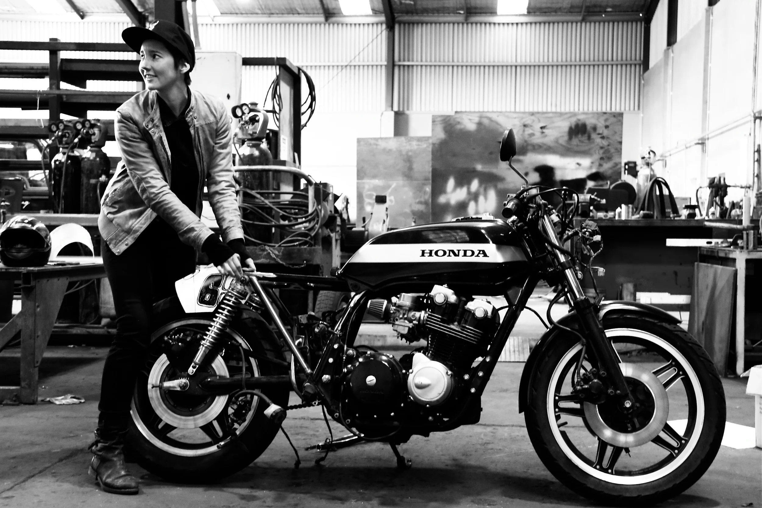 Rosie is currently in the process of following her dreams with insuppressible thirst. She rides a 1977 Honda CB550four Super Sport and is building a 1982 Honda CB750four with the help of her engineer husband Dan. She’s called “Bogan Audrey,” and it is a rat racer style café racer. Rosie’s inspiration for this dream machine: Audrey Hepburn in a little black dress. Rosie grew up around bikes and started out on dirt/motocross bikes. “My first race bike was at Yamaha pw50 at age four, I progressed through to come third in NZ for junior women and then had a big accident on my Honda CR125 (two-stroke) where I broke both my wrists at the same time.” Rosie's still got plans for the track and her big dream is to build her house around her workshop. She's working on her welding skills like a mad women and has all kinds of ideas for builds. He favorite kind of therapy is working on one of her many projects or going fast. See if you can catch her! 