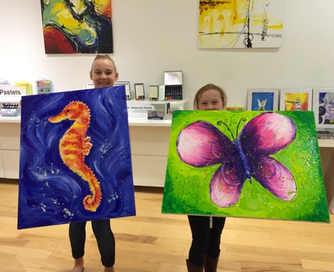 Student holding their artwork.