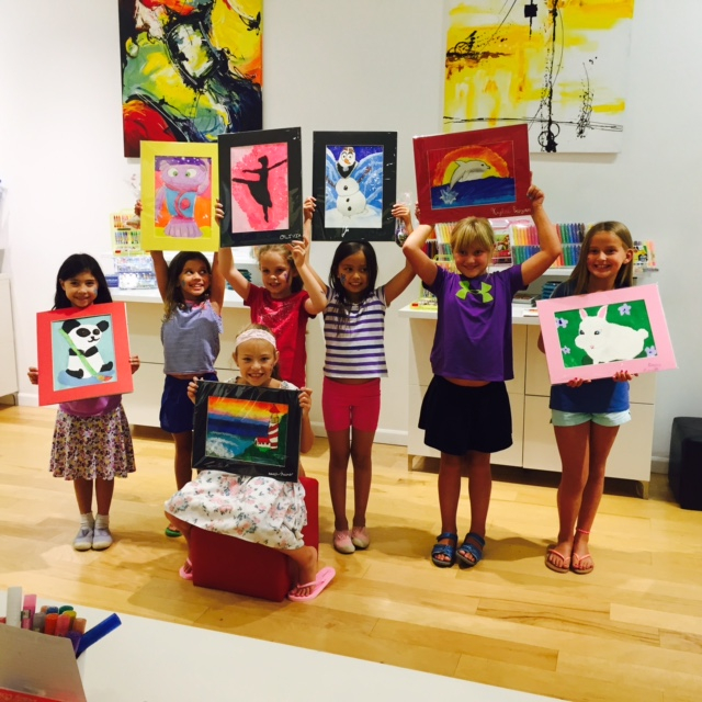 Student holding their artwork.