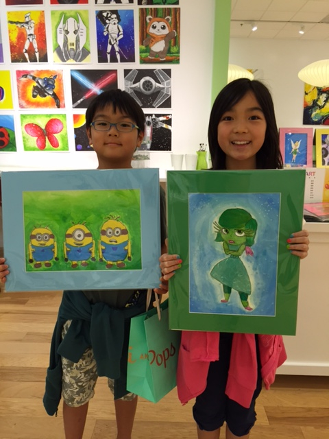 Student holding their artwork.