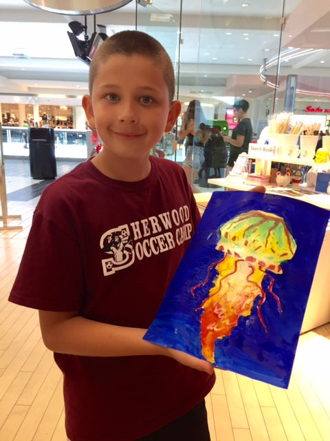 Student holding their artwork.