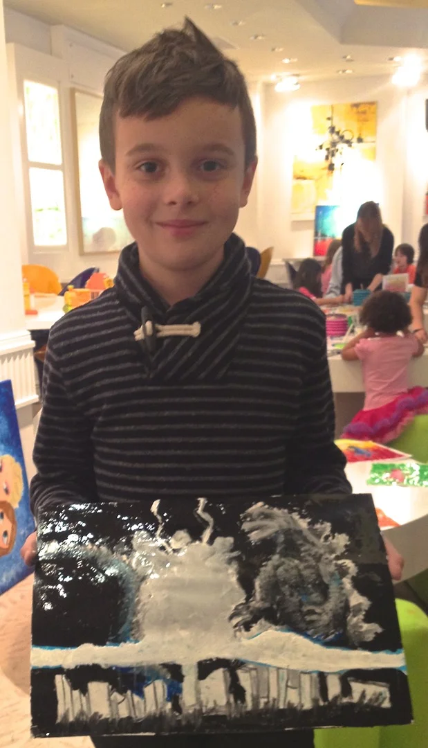 Student holding their artwork.
