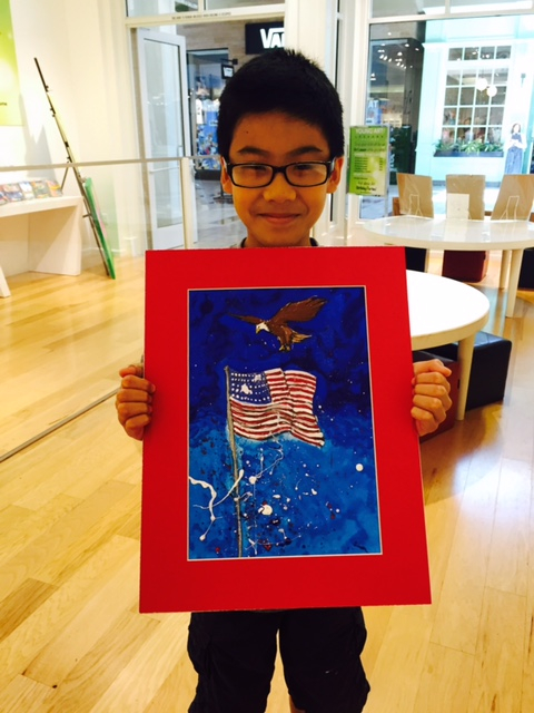 Student holding their artwork.