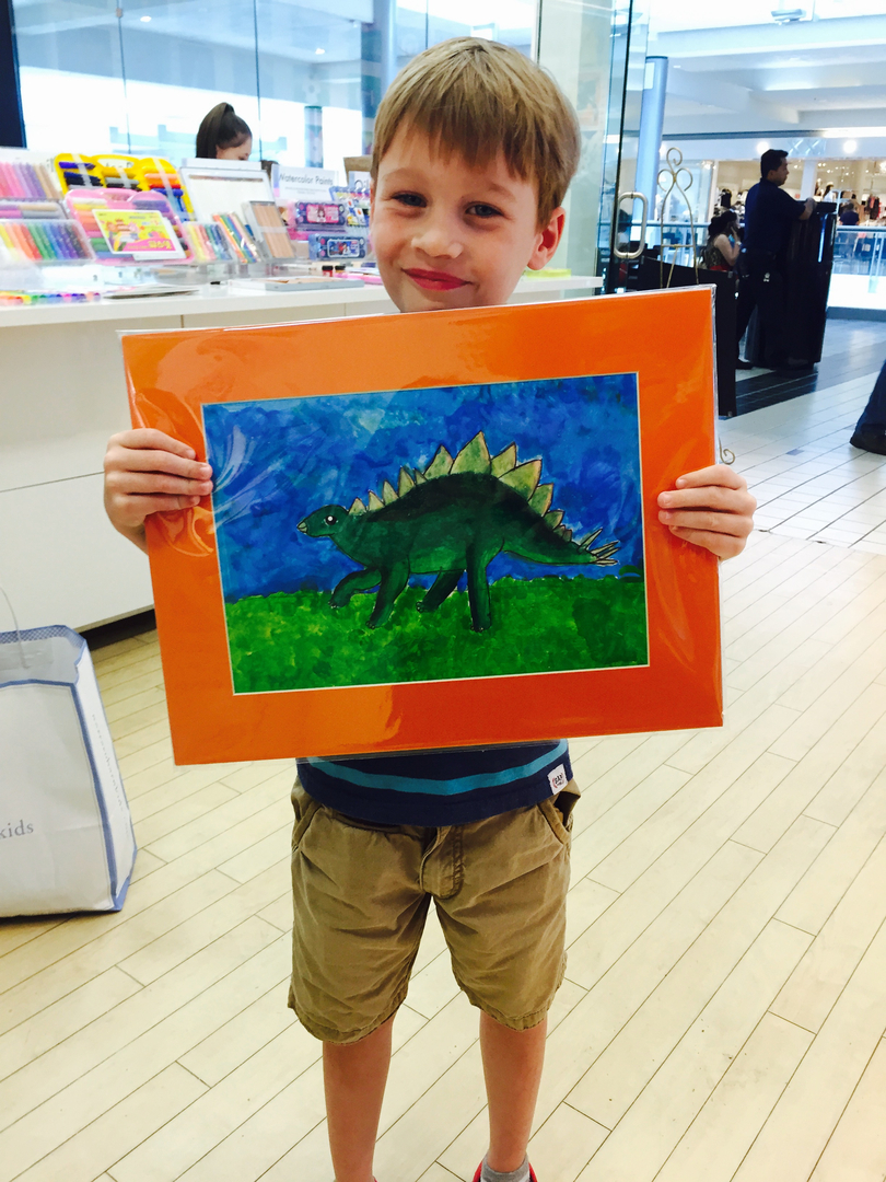 Student holding their artwork.