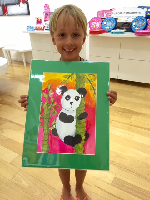 Student holding their artwork.