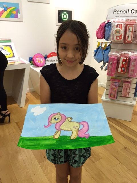 Student holding their artwork.