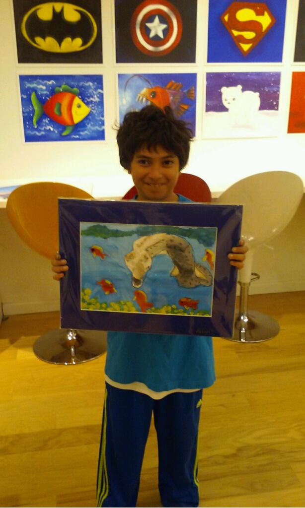 Student holding their artwork.