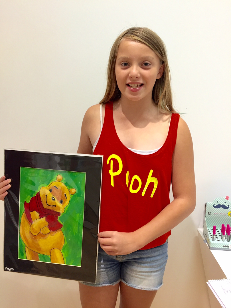 Student holding their artwork.