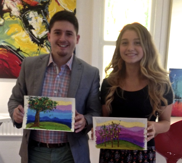 Student holding their artwork.