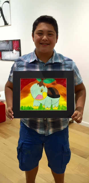 Student holding their artwork.