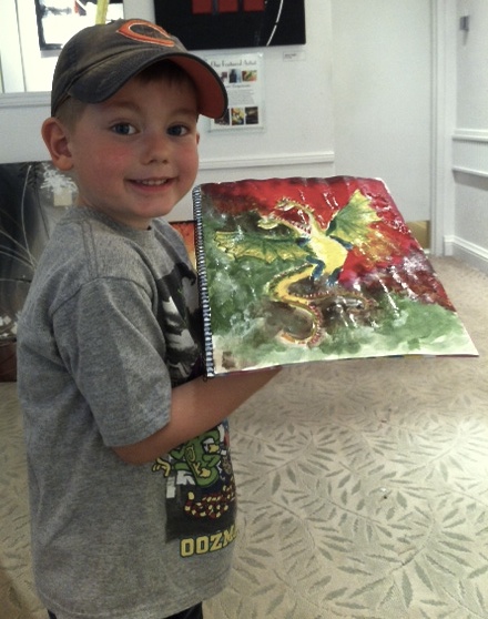 Student holding their artwork.