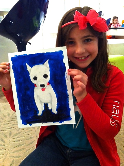Student holding their artwork.