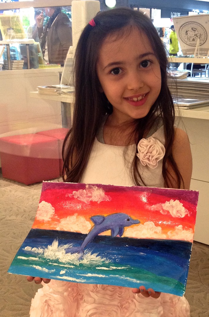 Student holding their artwork.