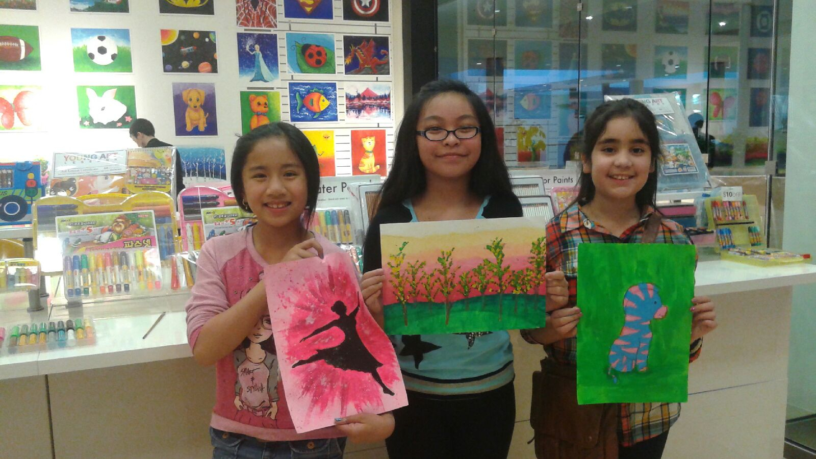 Student holding their artwork.