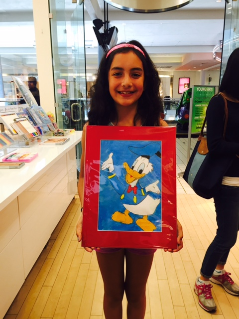Student holding their artwork.