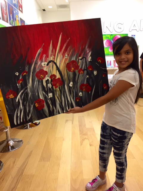 Student holding their artwork.