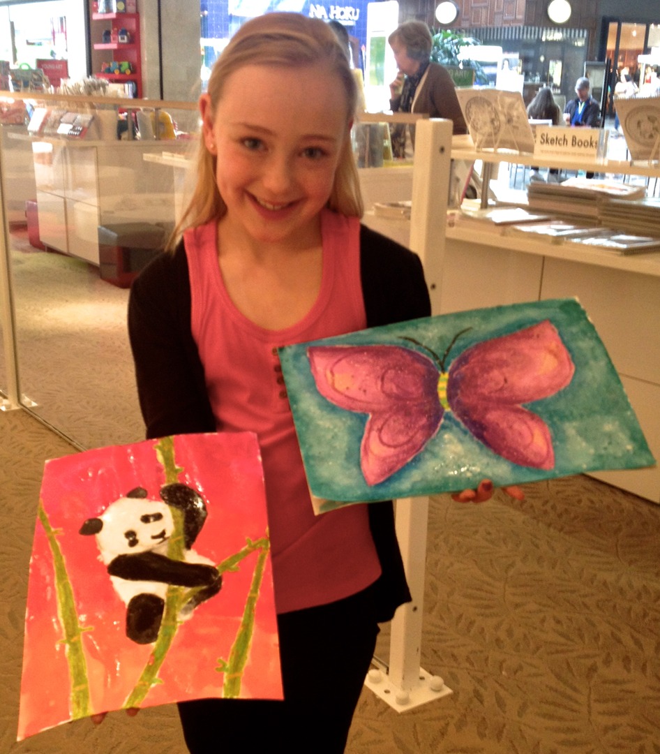 Student holding their artwork.