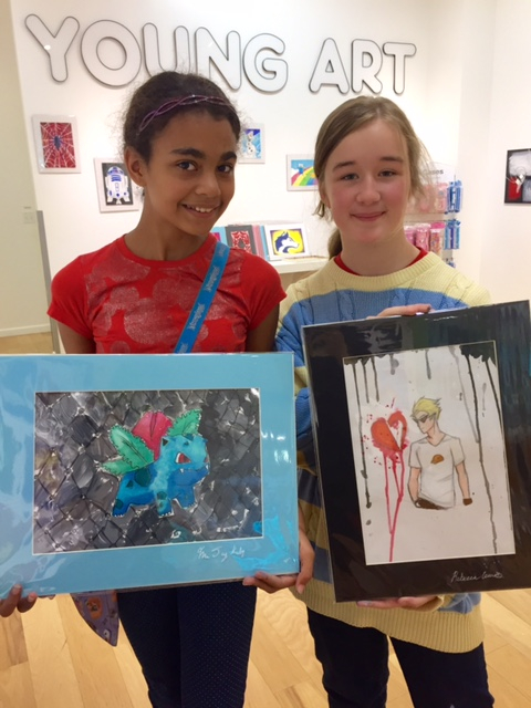 Student holding their artwork.