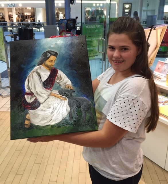 Student holding their artwork.