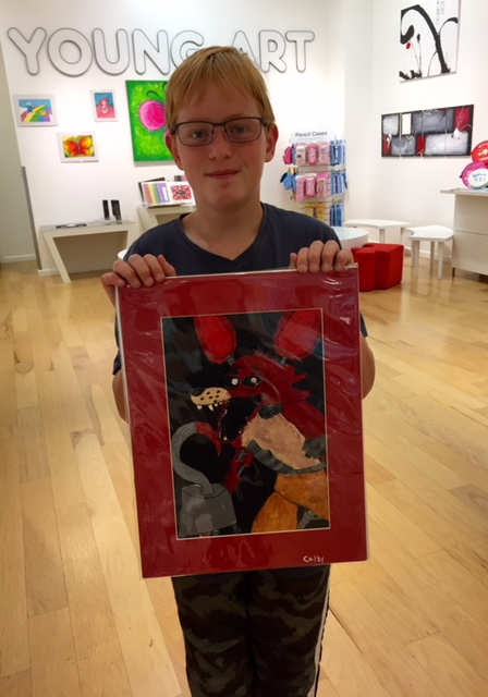 Student holding their artwork.