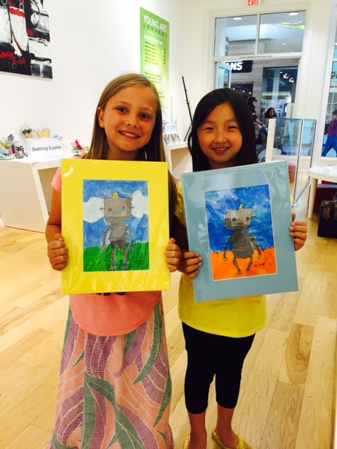 Student holding their artwork.