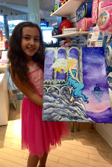 Student holding their artwork.