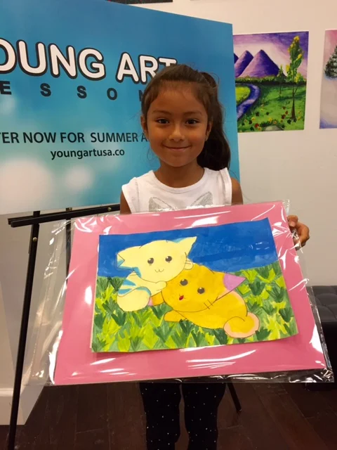 Student holding their artwork.