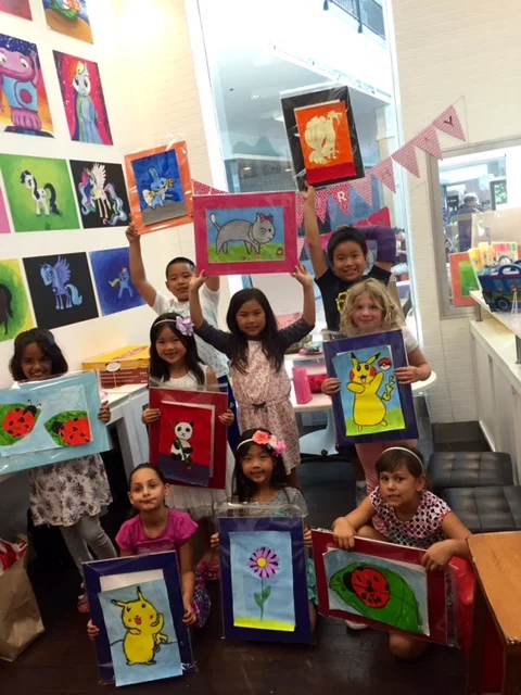 Student holding their artwork.