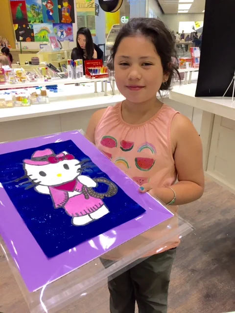 Student holding their artwork.