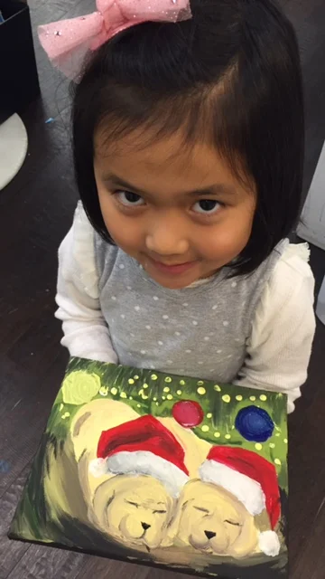 Student holding their artwork.