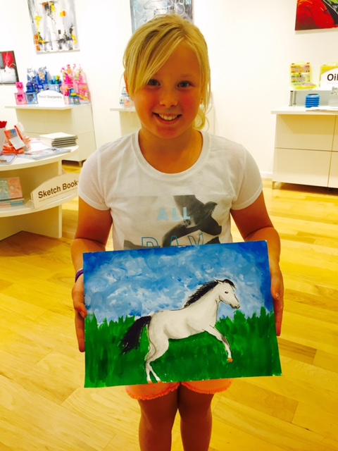 Student holding their artwork.