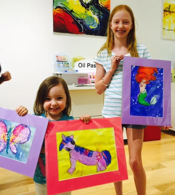 Student holding their artwork.