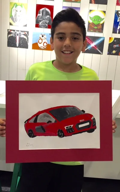 Student holding their artwork.