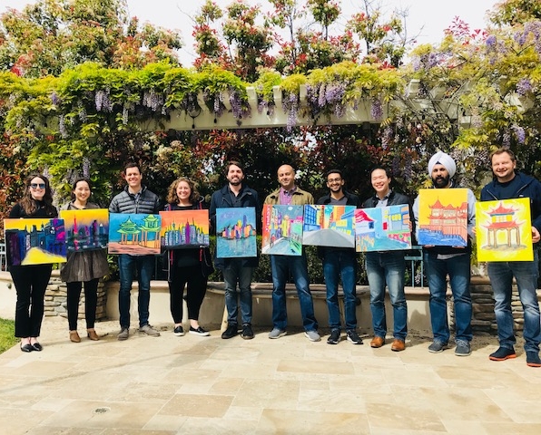 Image of adults holding their finished art pieces.