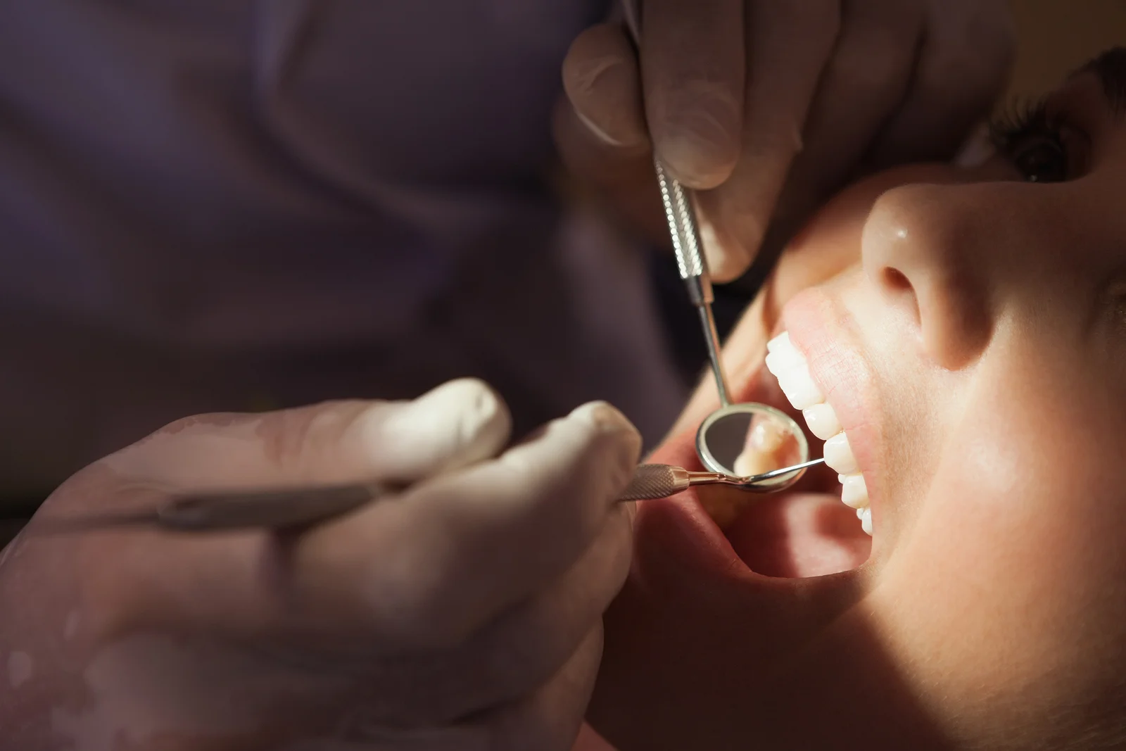 bigstock-Dentist-examining-a-patients-t-71349202.jpg