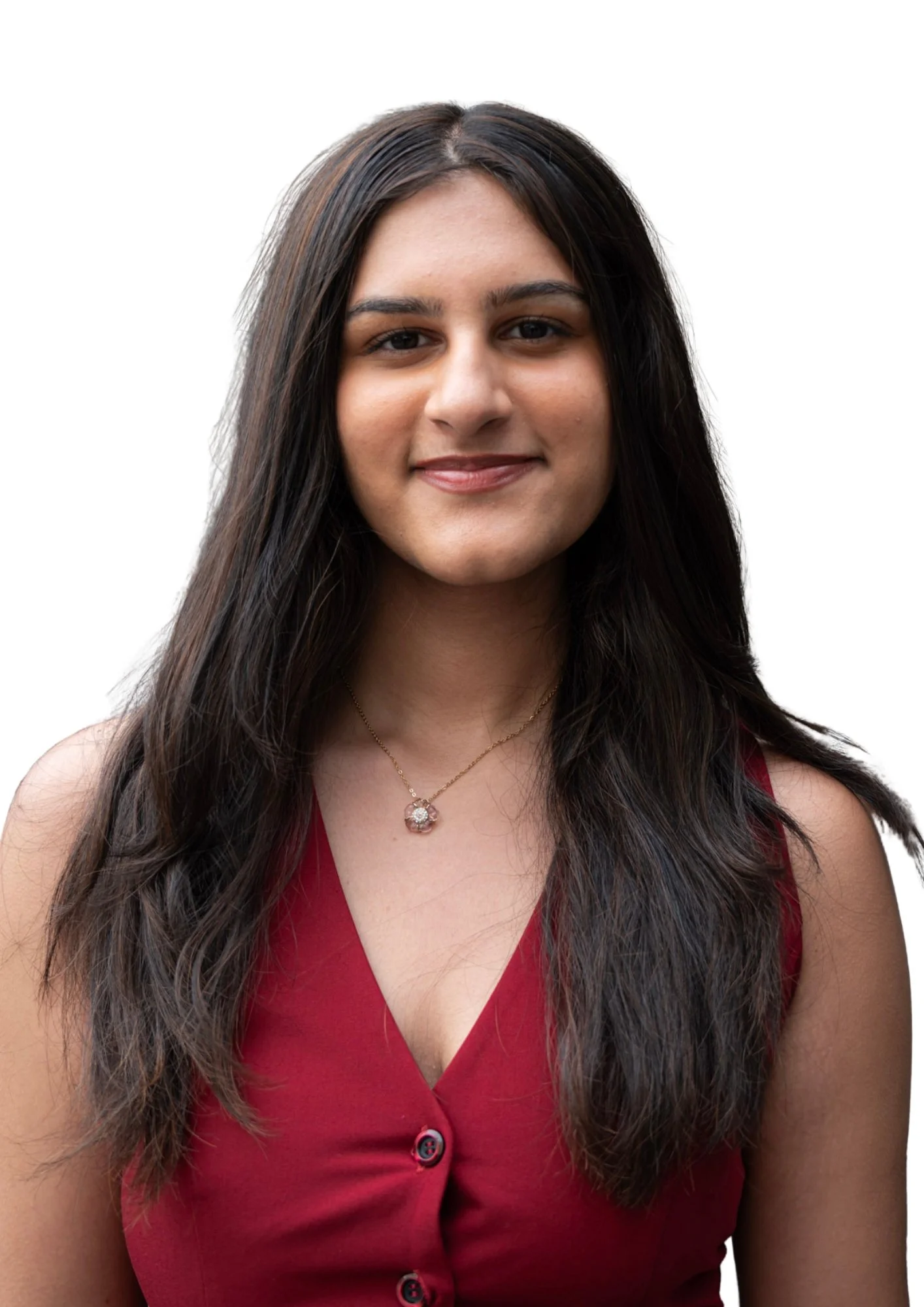 A woman with long dark hair wearing a red sleeveless top and a necklace, smiling against a white background.