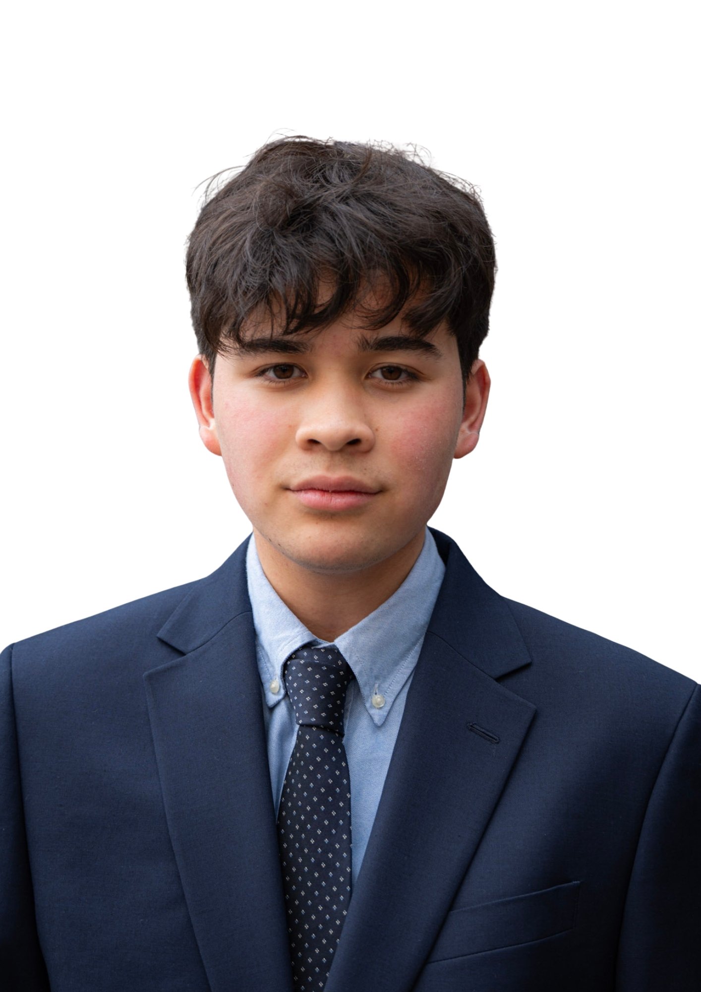 A young man dressed in a dark blue business suit, light blue shirt, and patterned tie, posing against a plain white background.