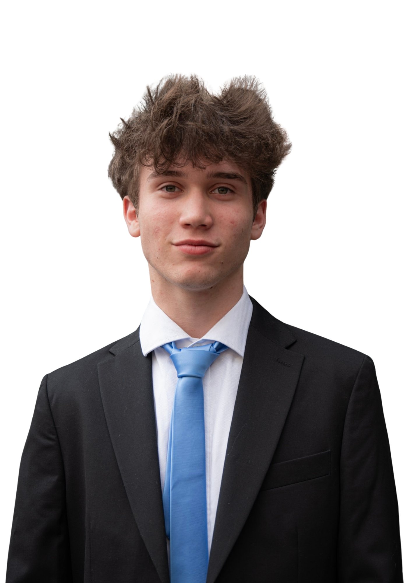 A young man in a black suit, white shirt, and blue tie, smiling slightly, with tousled brown hair, against a plain white background.