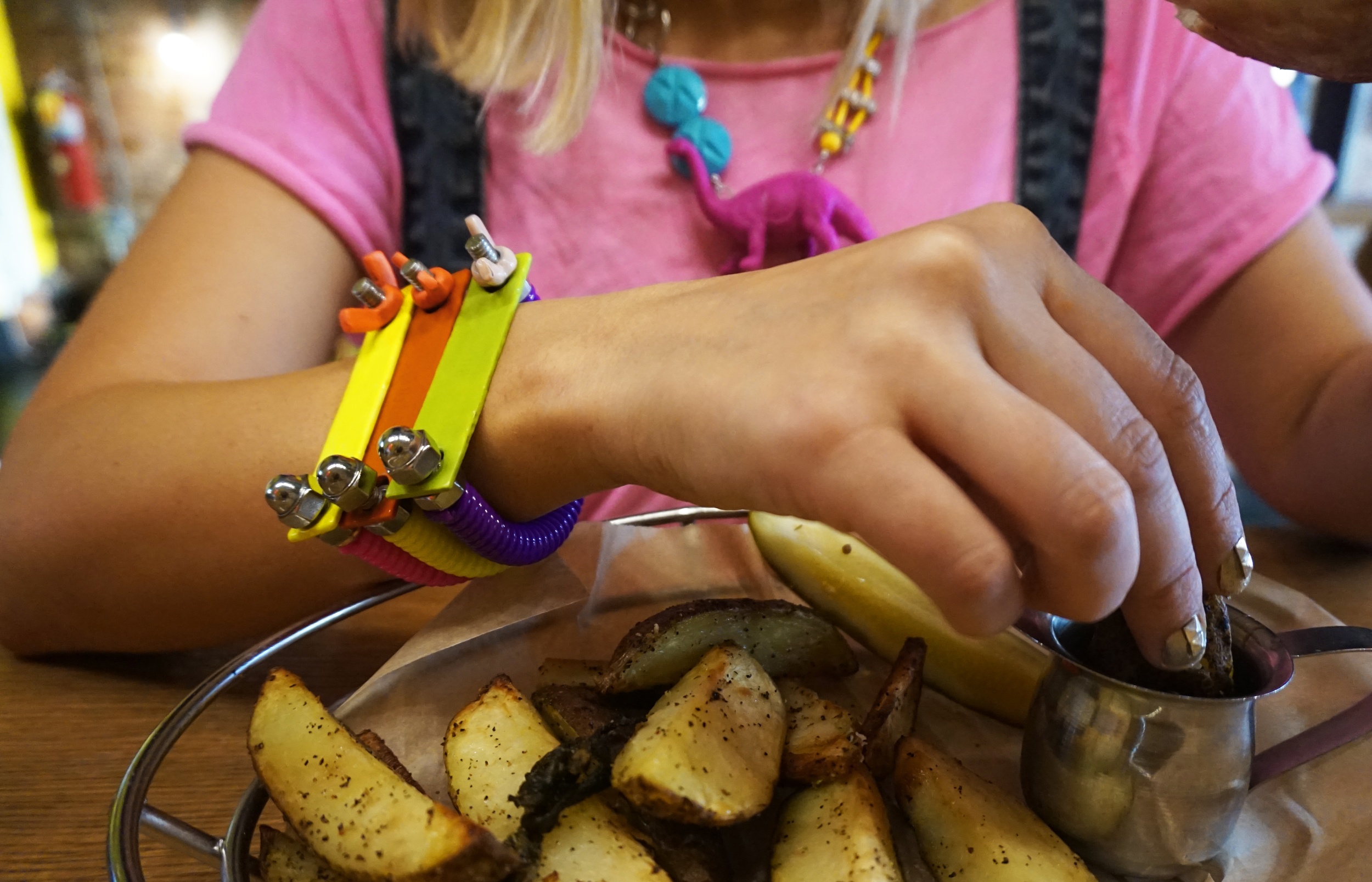 (from left): Issy Salomon Memphis bracelets in pink, yellow, & purple and Dinosaur necklace (available here ) 