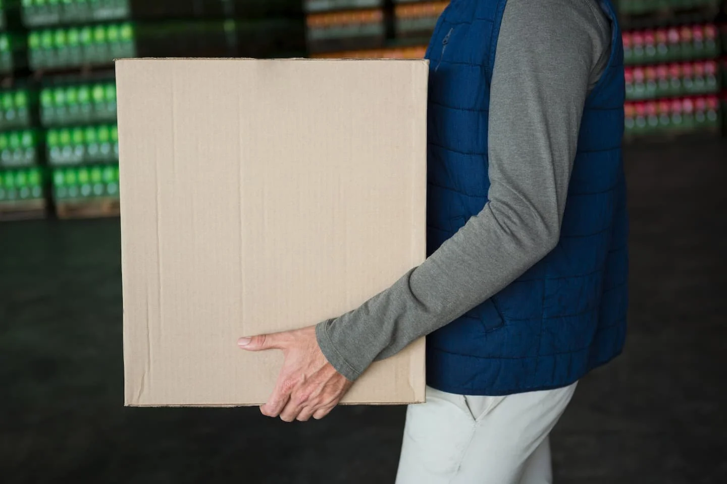 Person carrying a box in line with manual handling training