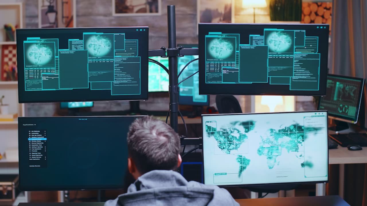 Picture of a person looking at multiple screens