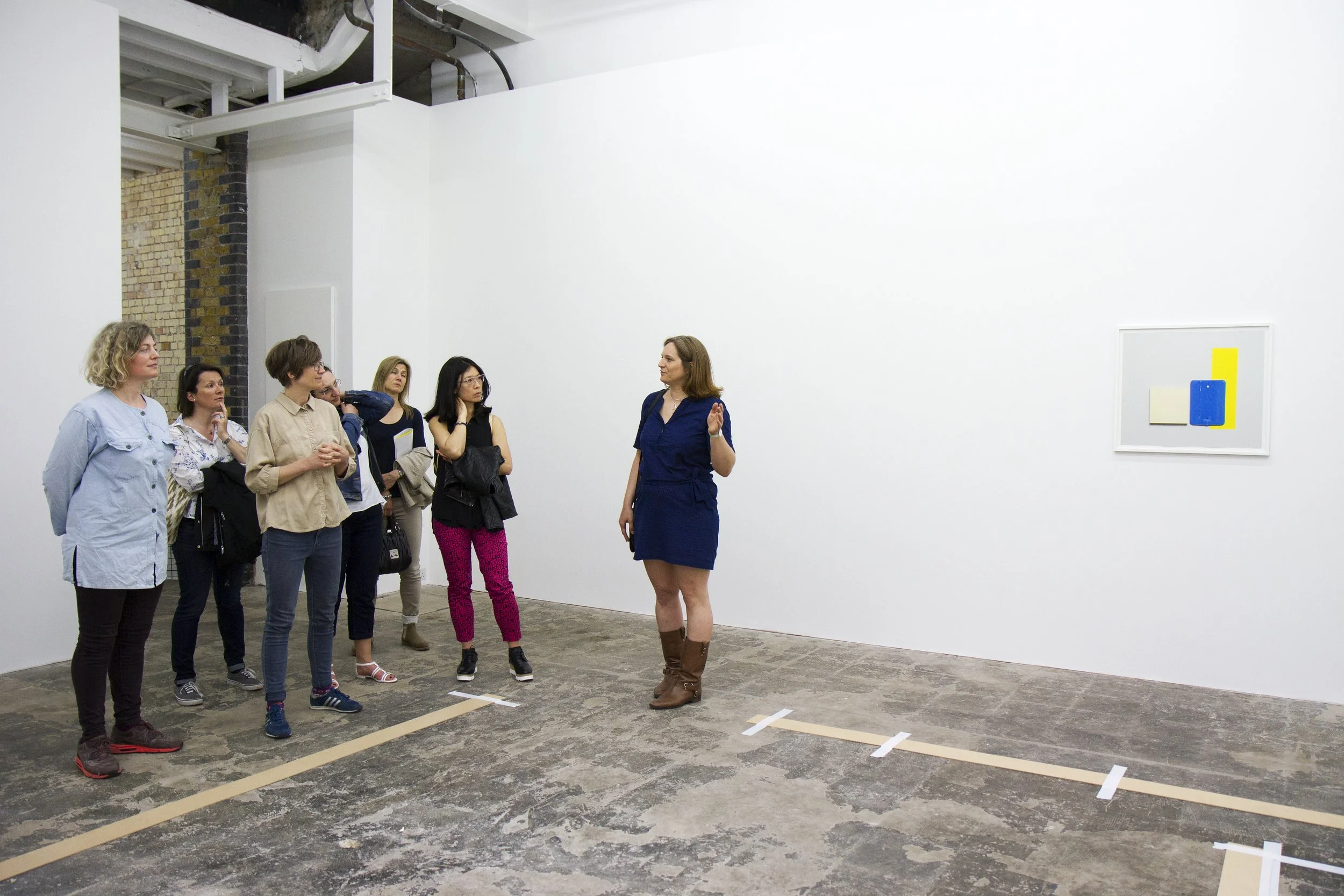 Sabine Casparie guiding visitors around an art gallery.jpg