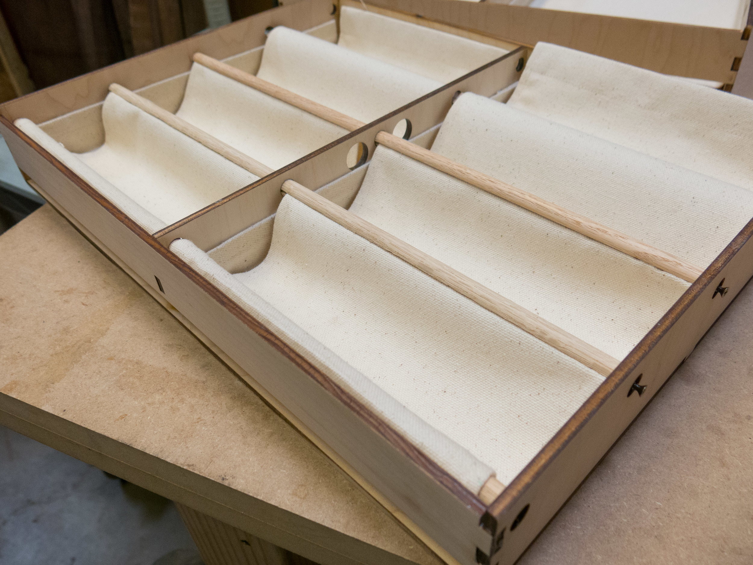 Fabric step 5 - Adding the remaining halves of the dowels on top of the fabric holds everything in place.