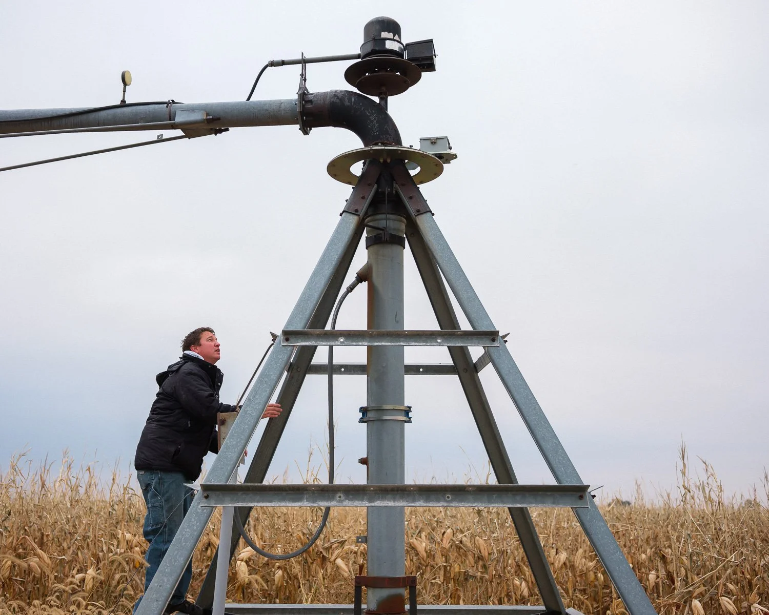 Farmer Jonathan Rempel checks an irrigation pivot that needs moving. His neighbors, friends, and family volunteered their machinery and labor to harvesting his crops after his farming equipment burned, York County, NE, for The New York Times, 2020 