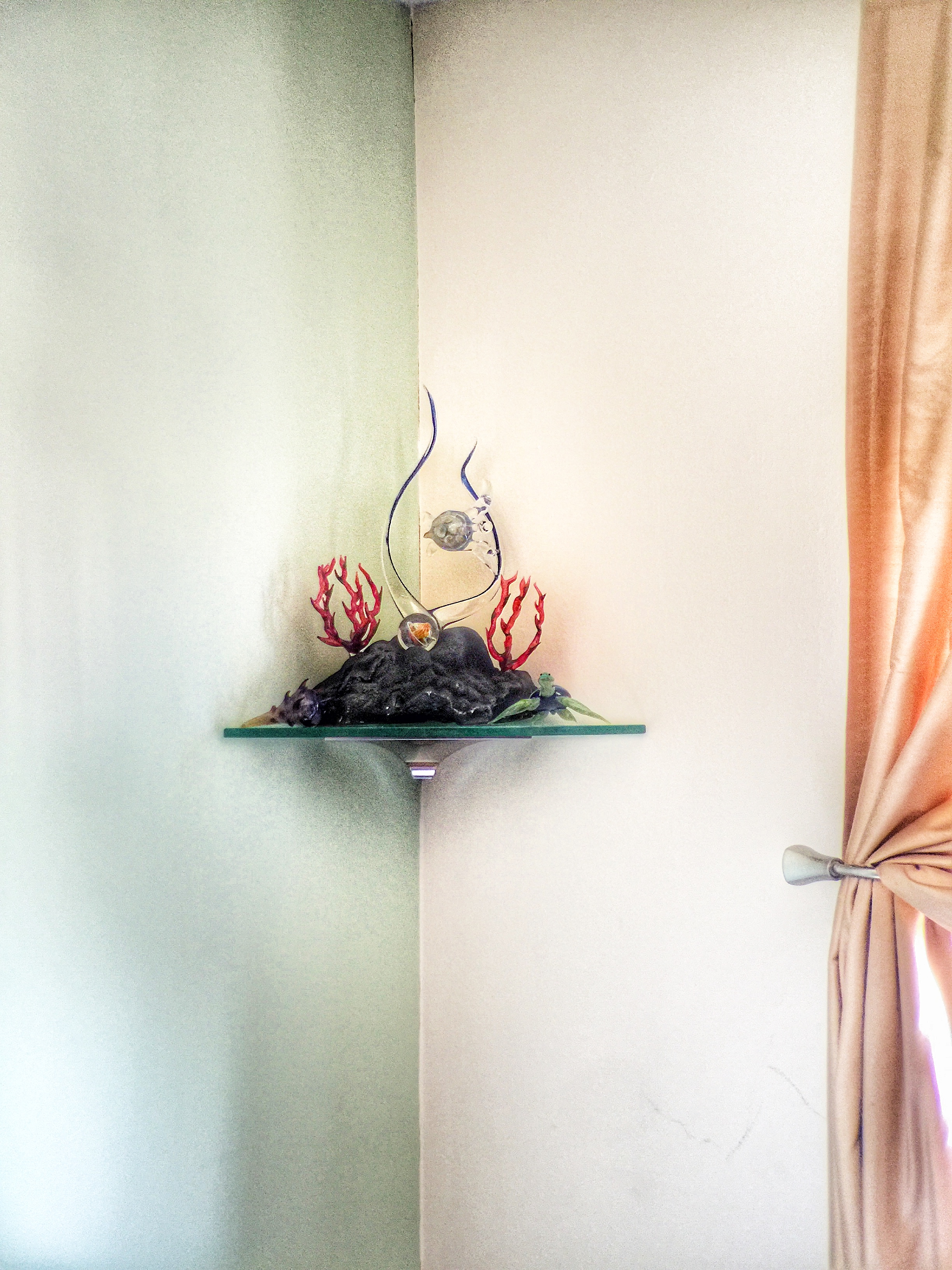 A small glass corner shelf was a perfect was to hold this families glass art.