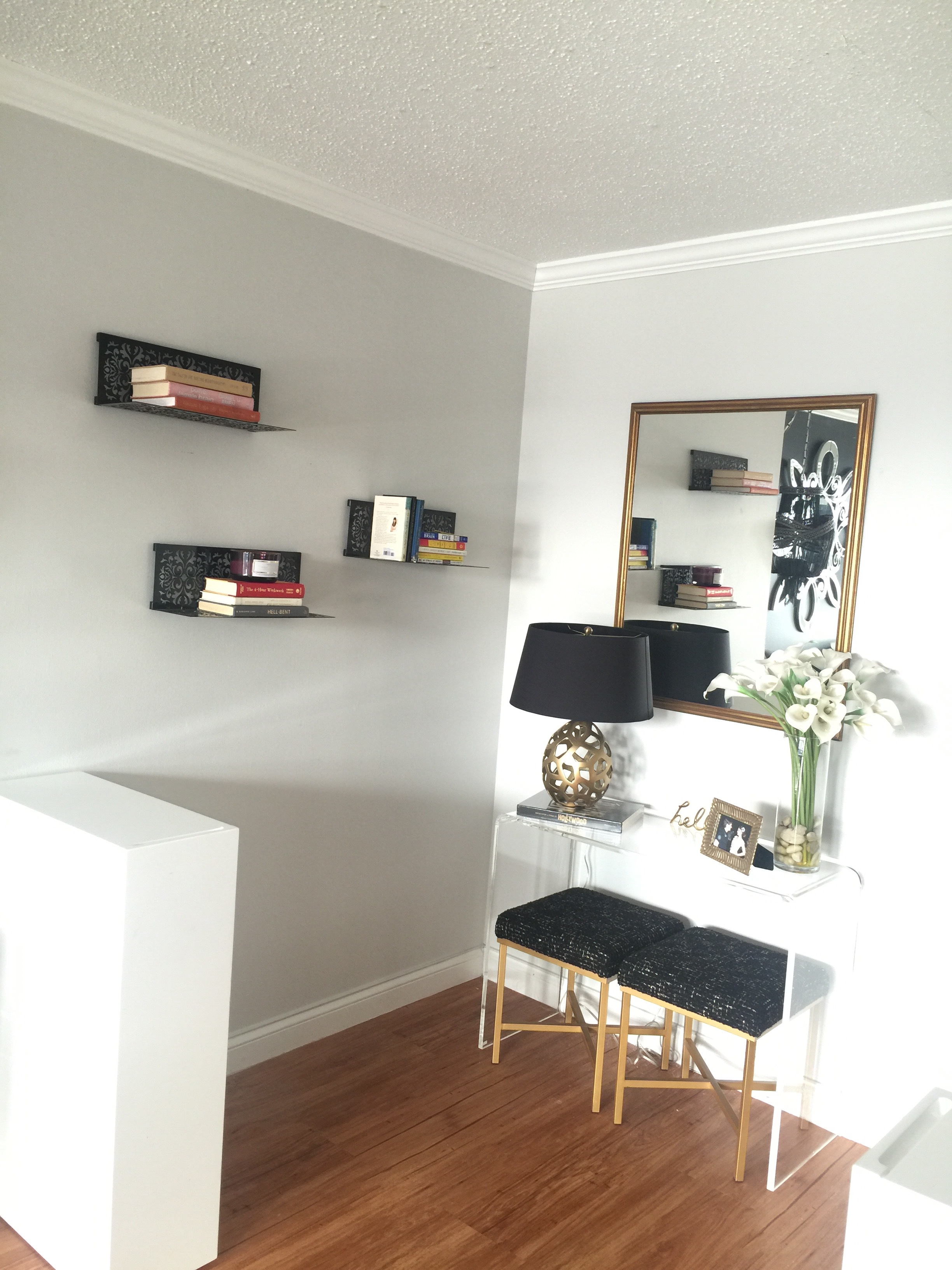 Black Metal floating shelves create interest with the rest of the decor in this entry way.