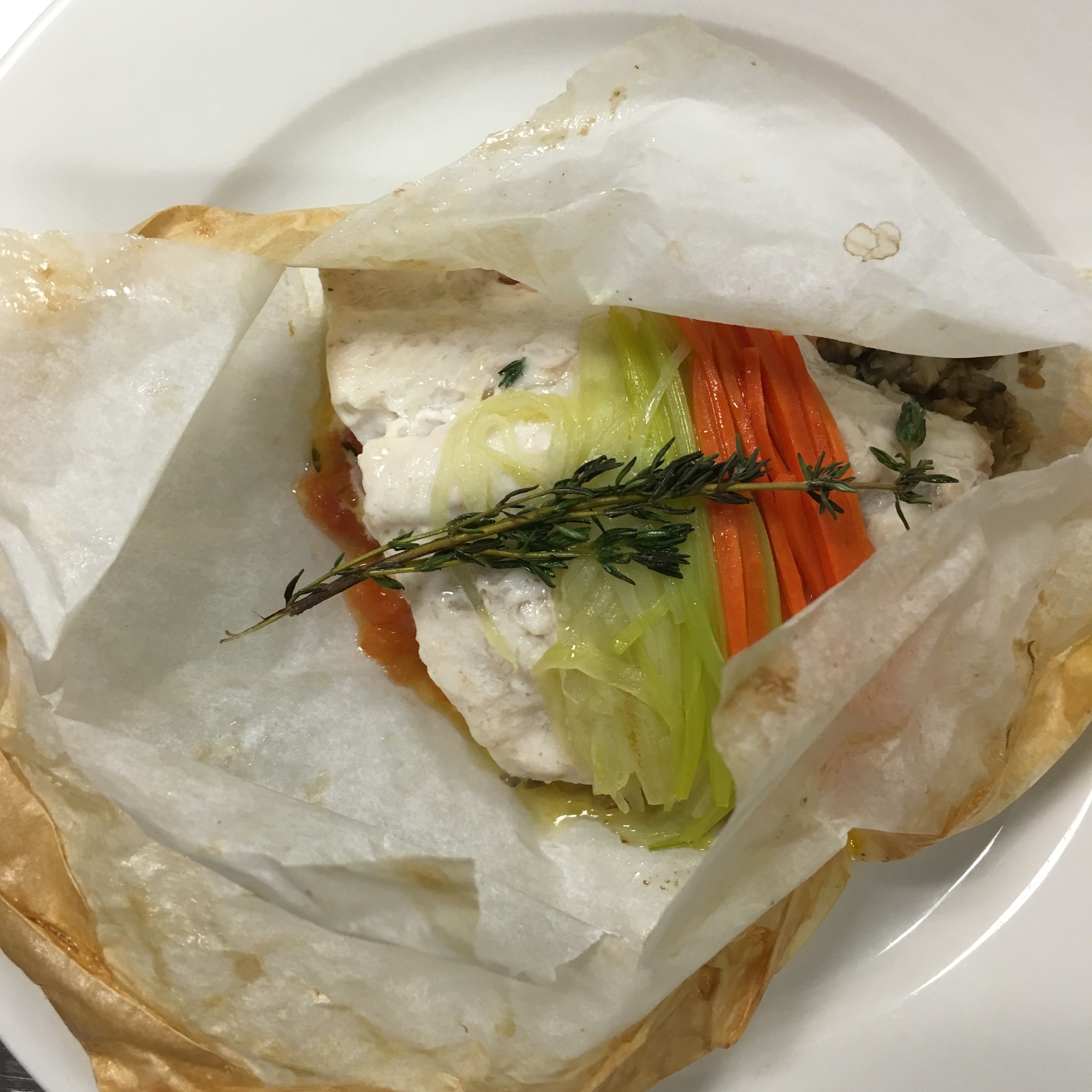FISH COOKED IN PARCHMENT PAPER, ALSO KNOWN AS "POISSON EN PAPILLOTES"