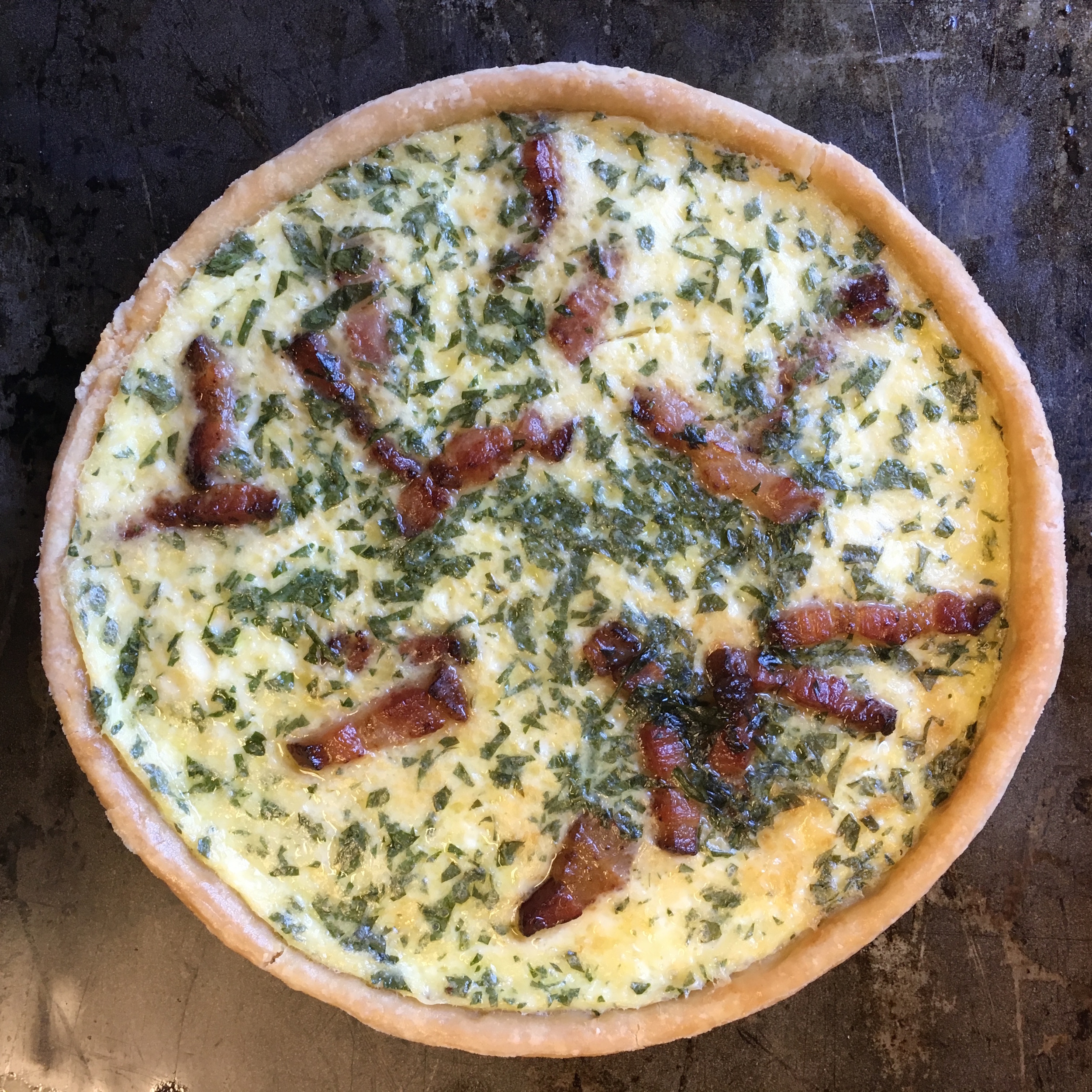 WE USED THE SAVORY TART DOUGH, PATE BRISEE, FOR THIS QUICHE. SURPRISINGLY THERE WAS ONLY ONE WHOLE EGG AND ONE WHOLE YOLK USED IN THE ENTIRE RECIPE. THE FILLING WAS MADE UP MOSTLY OF MILK AND HEAVY CREAM, WHICH LED TO A VERY LIGHT AND CREAMY FILLING. DELICIOUS!