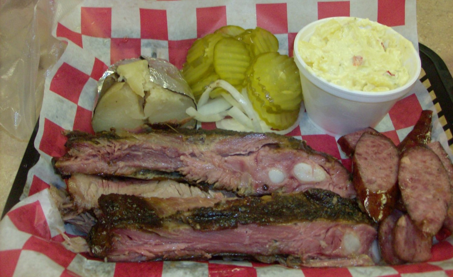 Bar-B-Que Plate (three meat: Ribs, Brisket, Sausage) with baked potato and potato salad